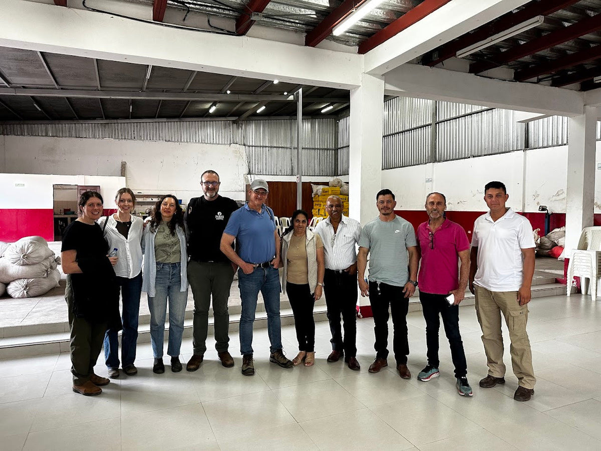 Group standing together inside a coffee warehouse in Nicaragua