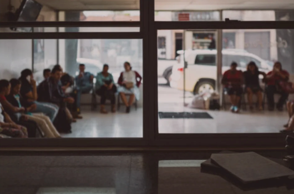 Group of producers gathered for a meeting, seen through a window