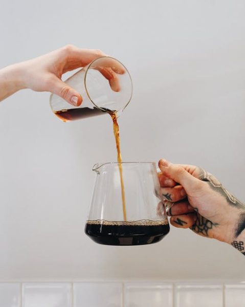 coffee being pured into a coffee cup